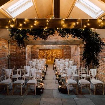 Chairs set out on each side of an aisle ready for a service.