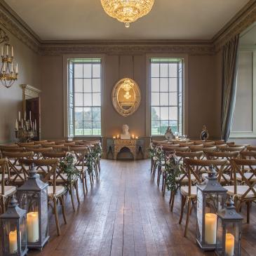 Seats and aisle with decorations for wedding celebration.