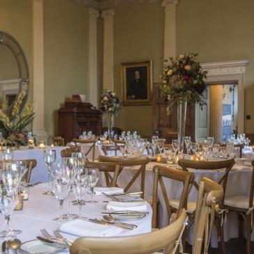 Tables and chairs laid out with floral decorations.