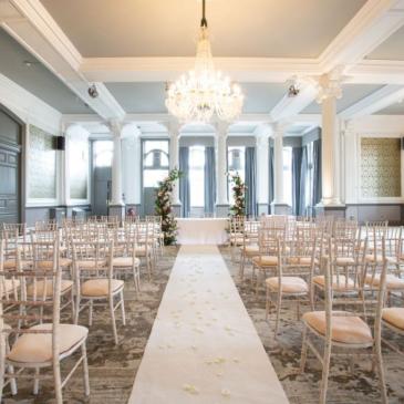 Aisle down the middle of a room heading towards a wedding ceremony