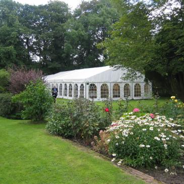 Large marquee in a beautiful garden.