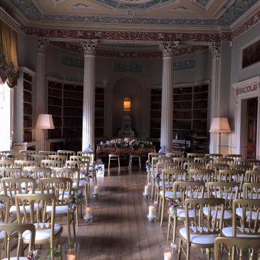 Chairs with an aisle facing towards a wedding ceremony. 