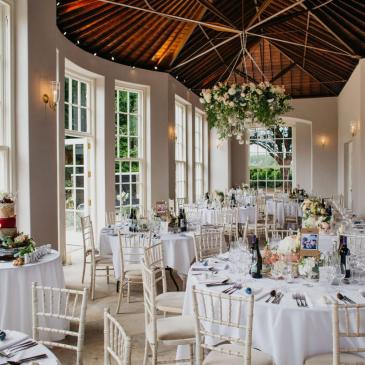 Tables and chairs set up for a wedding dinner. 