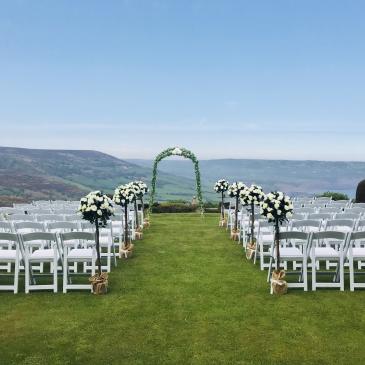 Chairs laid out on each side of an aisle ready for a wedding ceremony.