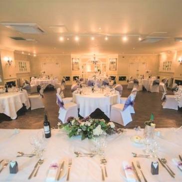 Tables and chairs set out for a wedding meal.