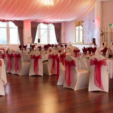 Tables with chairs and decorations for wedding dinner.