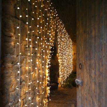 A wall in Sheriff Hutton Castle with hanging fairy lights.