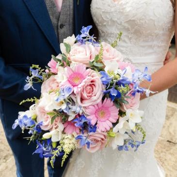 Bride with a beautiful and big bouquet of flowers.