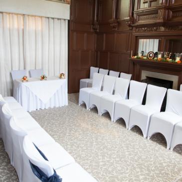 Chairs in a line each side of a head table for wedding couple