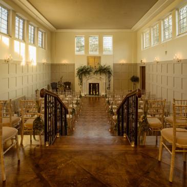 Seats set out each side of an aisle for a wedding.
