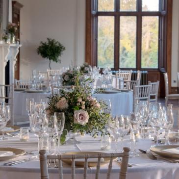 Seating with tables and floral centre pieces. 