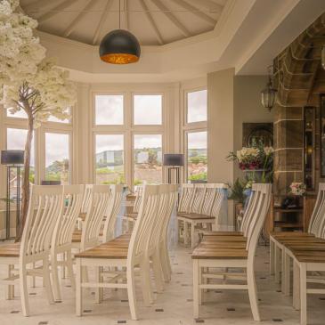 Chairs laid out in rows facing wedding ceremony.