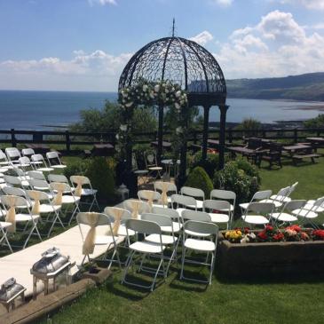 Outside shot of chairs laid out for a wedding ceremony.