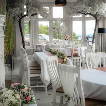 Chairs and tables set out for a wedding dinner.