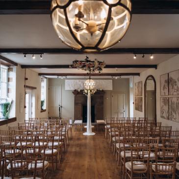 Main room in Egton Manor full of chairs lined in rows, ready for a wedding