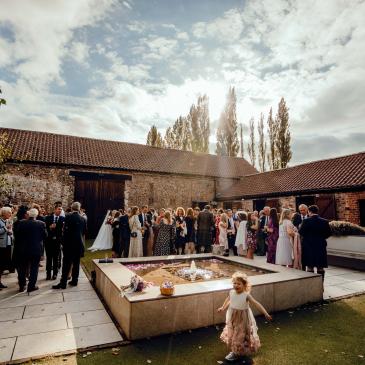 Outside wedding venue with guests enjoying the event.