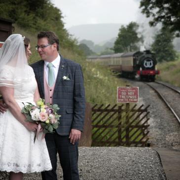 Bolton Abbey Station image of bride and groom stood on a railway platform