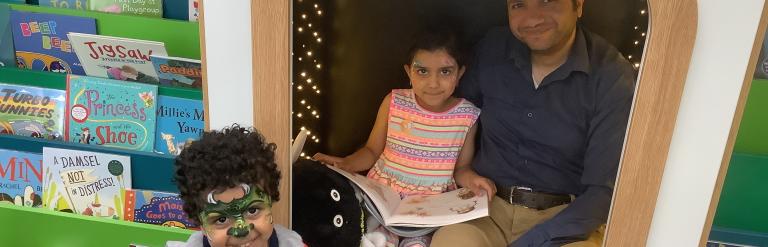 3 children reading in the library