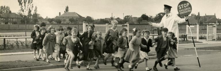 A group of school children crossing a road
