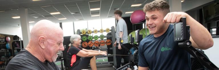 A member of our Active North Yorkshire team showing a customer how to use a rowing machine
