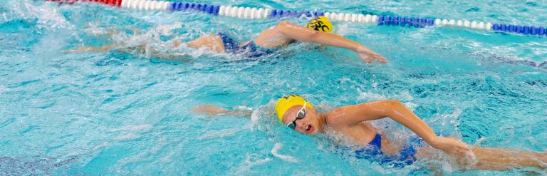 Two people swimming in a lane at Harrogate Leisure and Wellbeing Hub's pool