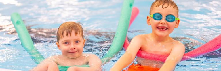 Two young boys using floats in the swimming pool at the Ripon Leisure and Wellbeing Hub - The Jack Laugher Centre