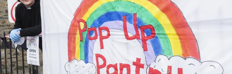 A pop up pantry sign with a rainbow