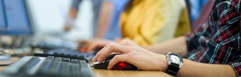 People typing on a computer.