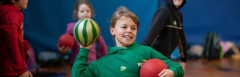 A young boy throwing a ball