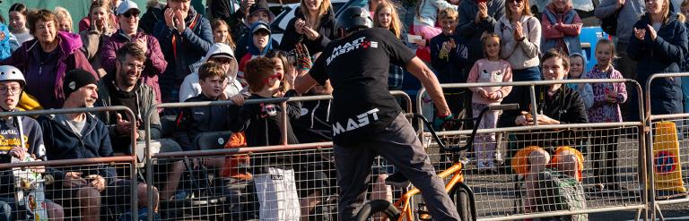 Cyclist greeting a crowd