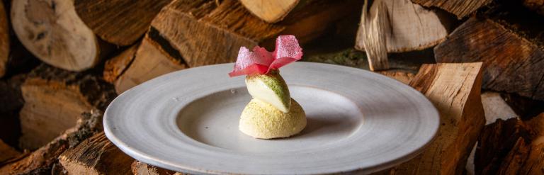 Photo of a plate with an item of food from the menu at the Black Swan on logs of wood 