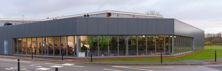 A view of the outside of Northallerton Leisure and Wellbeing Hub, people exercising are just visible within