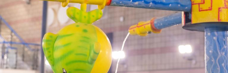 A showerhead shaped like a fish spraying water in the swimming pool at Northallerton Leisure and Wellbeing Hub