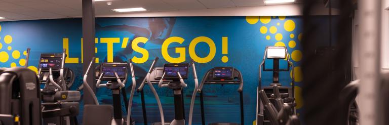 A view of the gym at Stokesley Leisure and Wellbeing Hub with "let's go" written on the wall 