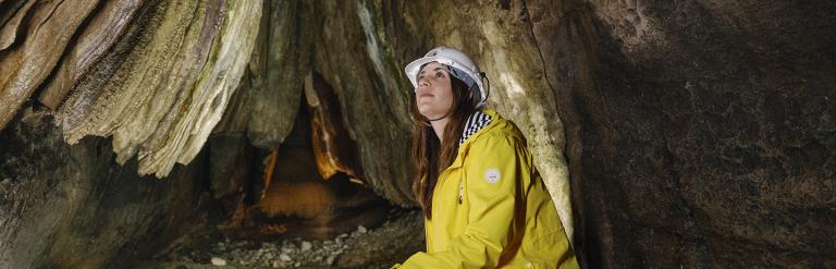 Person sitting in a cave in the Yorkshire Dales. Credit Tom Arber and Visit North Yorkshire