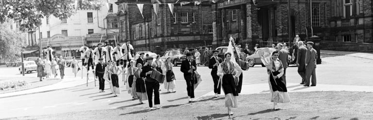 Harrogate’s French Week parade, passing in front of the Royal Baths during the 1950s. From the Bertram Unné photographic collection.