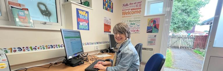 Sarah Knowles sitting at a desk working on a computer