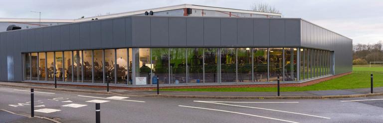 A view of the outside of Northallerton Leisure and Wellbeing Hub, people exercising are just visible within