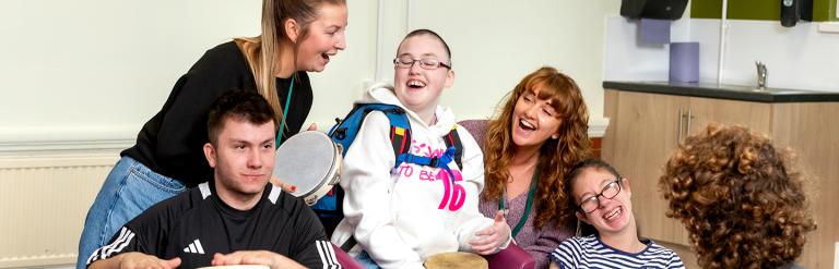 Small group of people enjoying playing musical instruments.