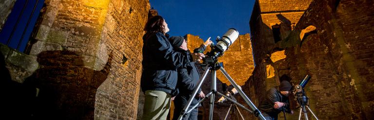 Group of people stargazing at Bolton Castle. Credited Stephen Garnett