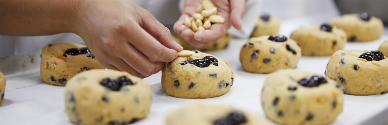 Member of the team at Bettys putting the finishing touches to cakes