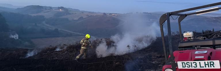 An image of a man fighting the wildfires. 