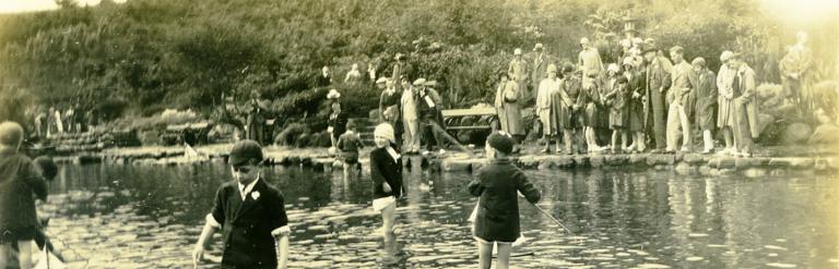 Children are pictured paddling in the shallow model yacht ponds at Peasholm Lake in Scarborough. From a collection of Scarborough and Whitby photographs dating from 1929